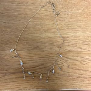 Gold colored charm necklace